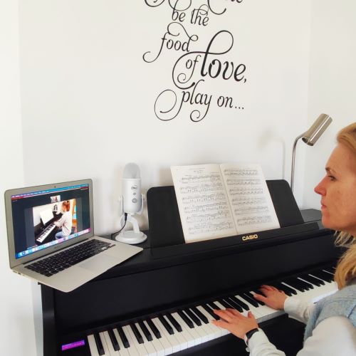 Debra teaching piano over a video call